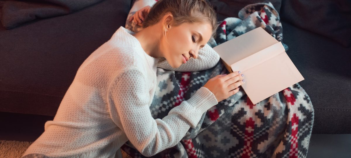 Woman sleeping while studying messing up her sleep pattern.