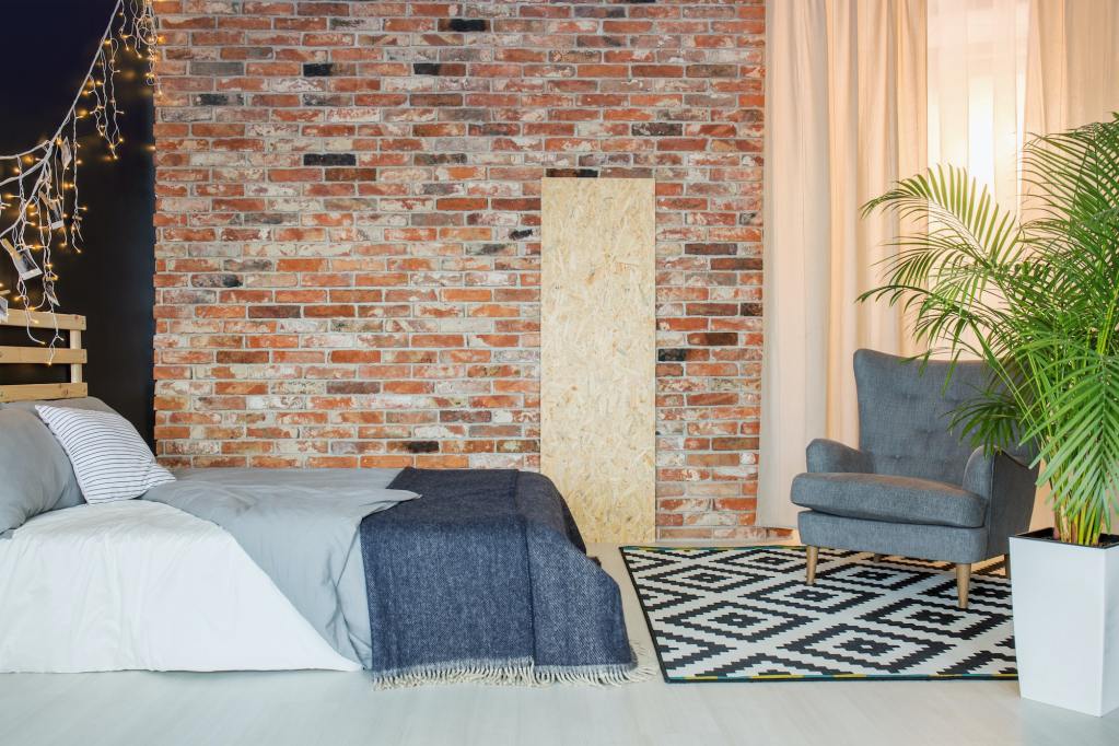 Bedroom with brick wall.