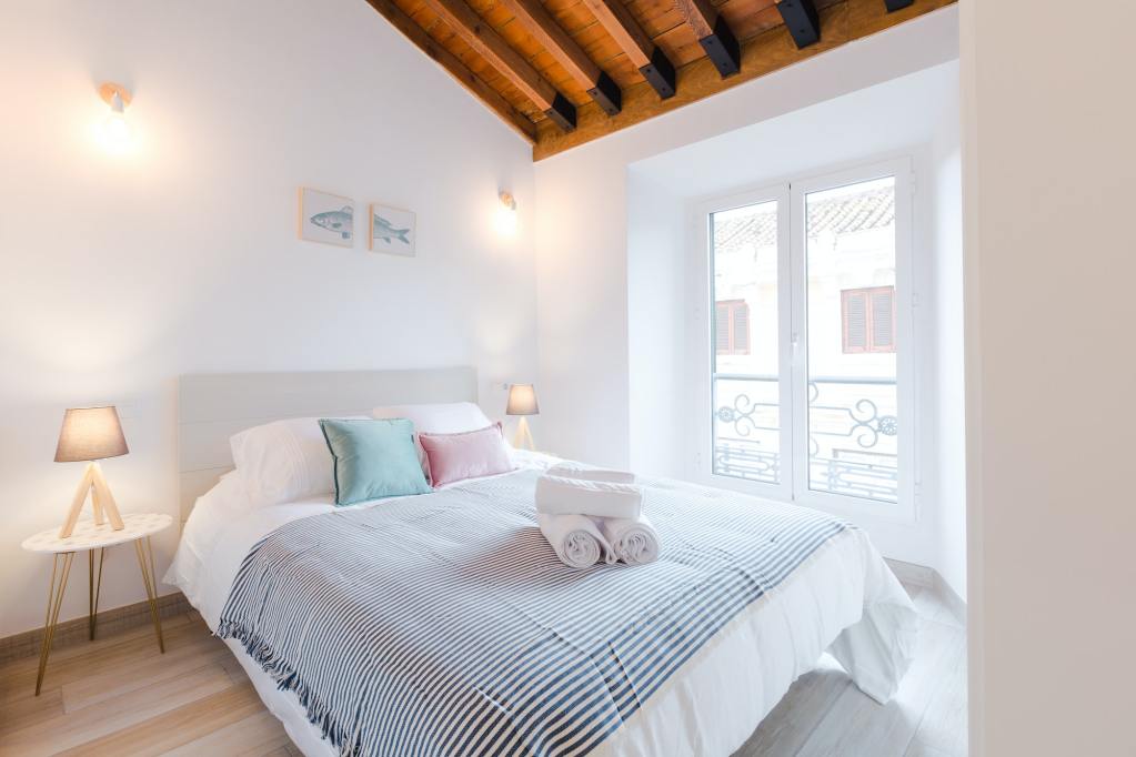 Cozy bedroom with a big bed that could use a split box spring