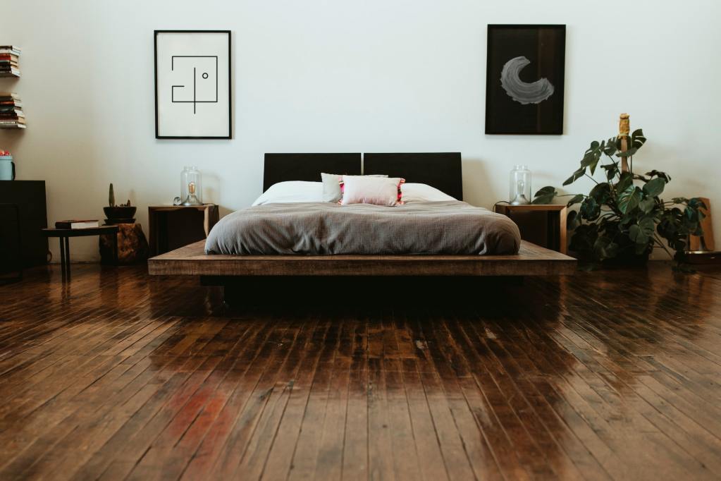 Will A Waterbed Crash Through My Bedroom Floor? Industrial bedroom with dark wooden floors.