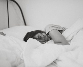 A woman testing a mattress