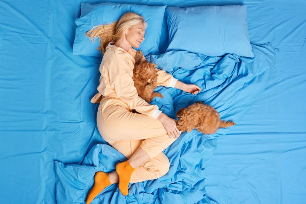 A woman sleeping comfortably. 10 Healthy Sleeping Habits To Build.