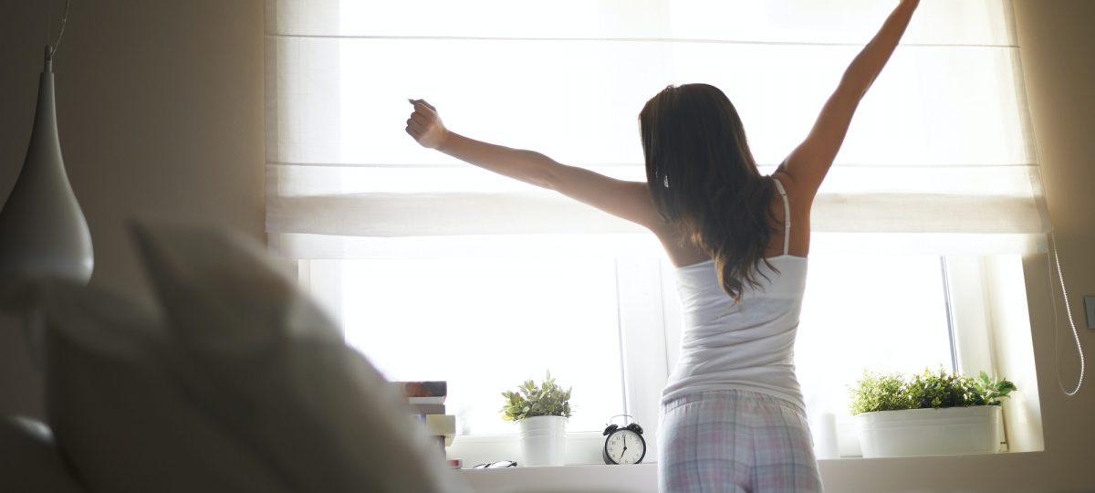 Woman stretching after sleeping.