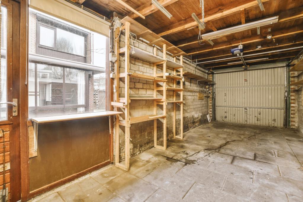 Spacious garage with brick walls. A bedroom could go over the garage.