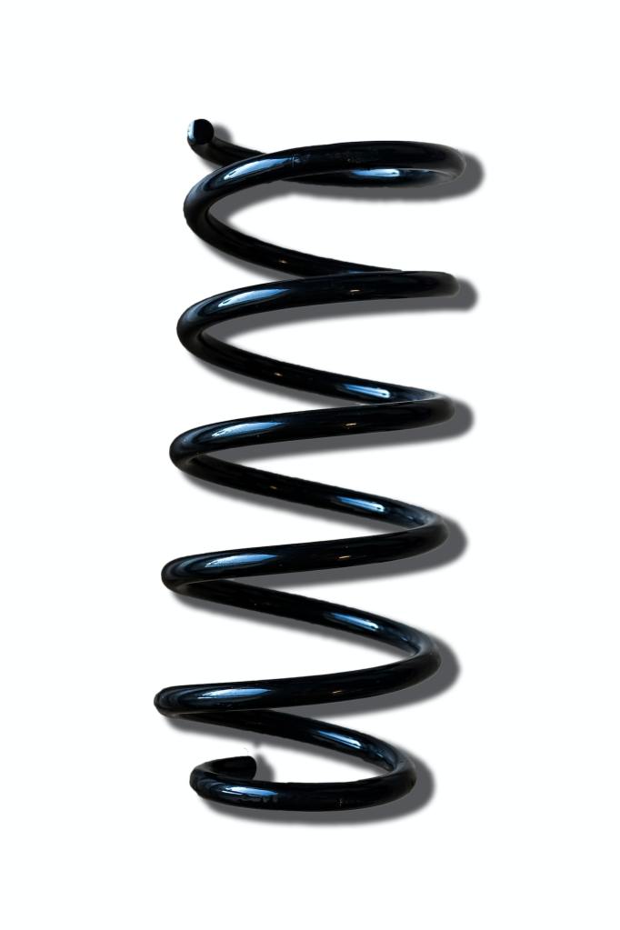 Vertical shot of a shock absorber coil spring isolated on a white background.